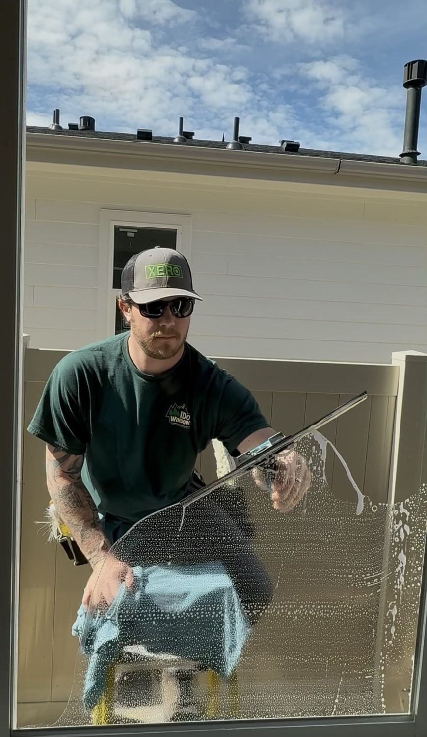 I Do Windows technician squeegeeing a window in the Treasure Valley